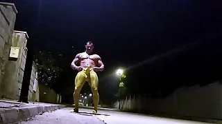 Spandex muscle man jerks off on a public street